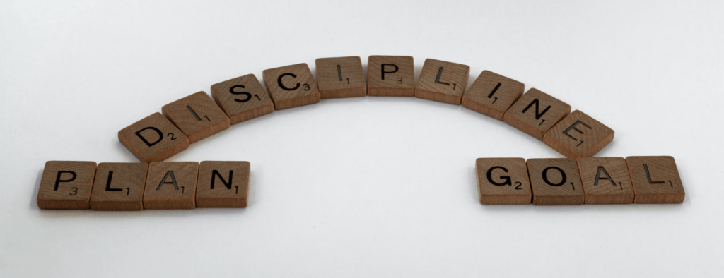 Planning with discipline equals a goal image created from scrabble letters